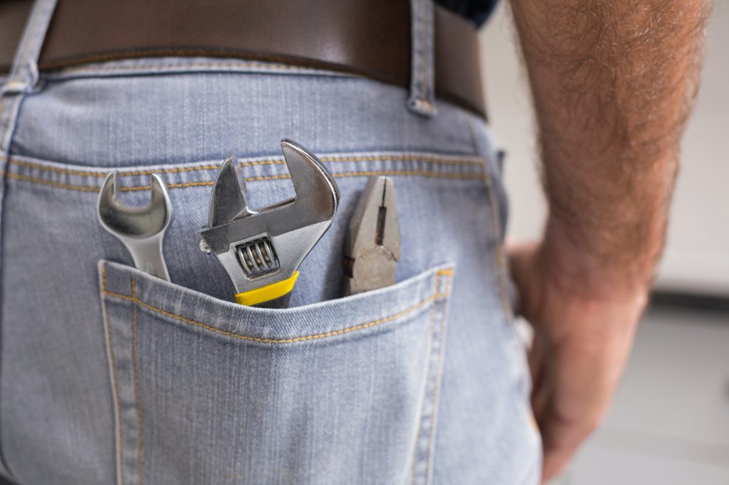handyman-with-tools-in-back-pocket-in-the-kitchen